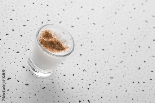 Shot glass of milk with cinnamon