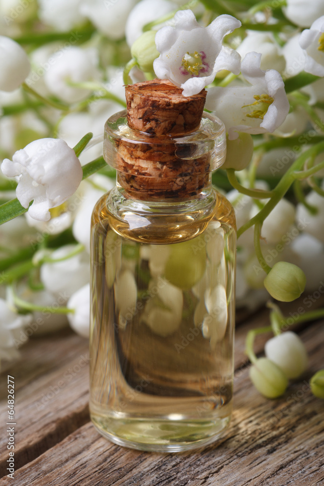 essence in a glass bottle of lily of the valley flowers essence in a glass bottle of lily of the valley flowers