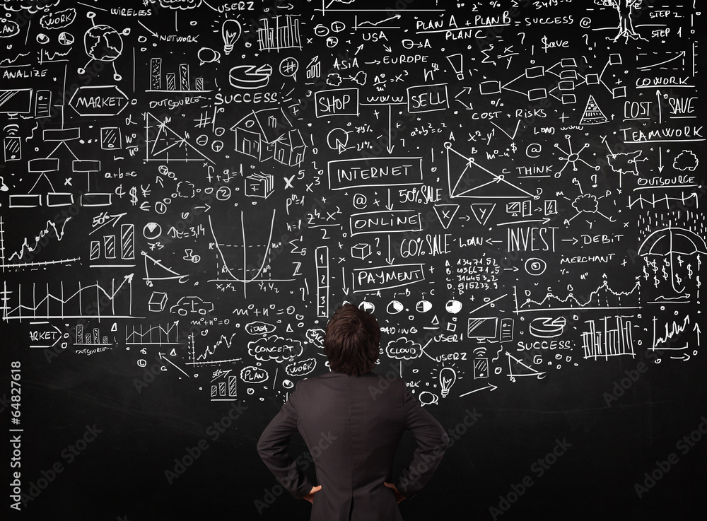 Businessman standing in front of drawn charts on a blackboard Businessman standing in front of drawn charts on a blackboard