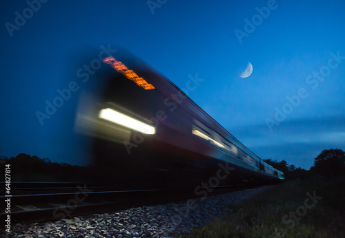 Train speeding passed in blur at night