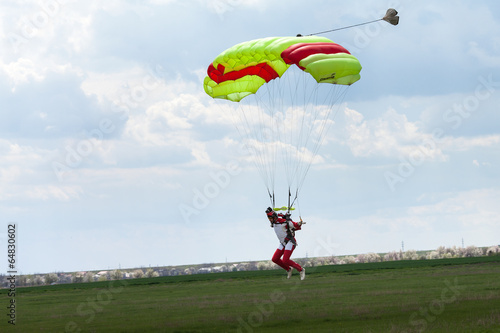 Skydiver in the sky, parachute landing