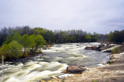 Threshold of the mountain river and wet stones photo