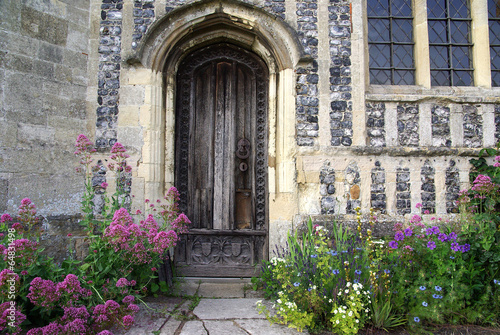 Door of an English church with flowers