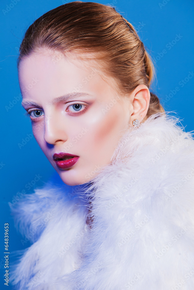 beautiful woman in white cape of feathers. Fashion photo
