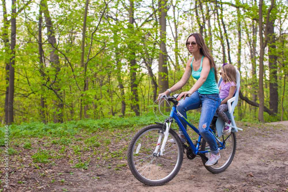 Mother and daughter riding bicycle at the park Mother and daughter riding bicycle at the park