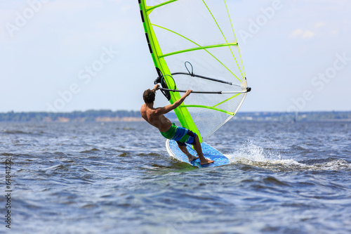 Rear view of young windsurfer