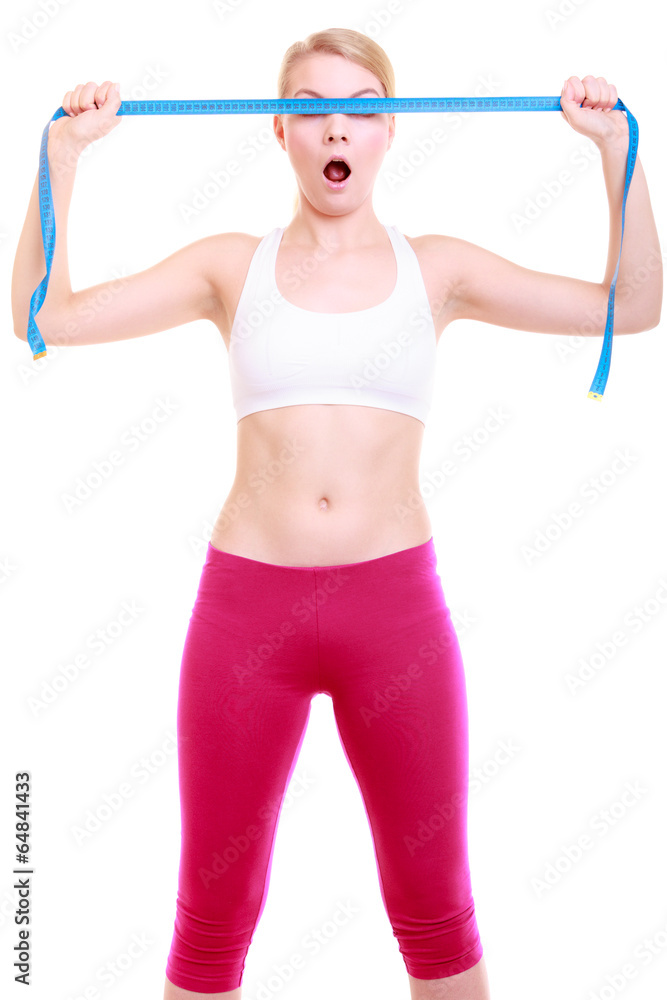 Fitness girl fit woman covering her eyes with measuring tape Fitness girl fit woman covering her eyes with measuring tape