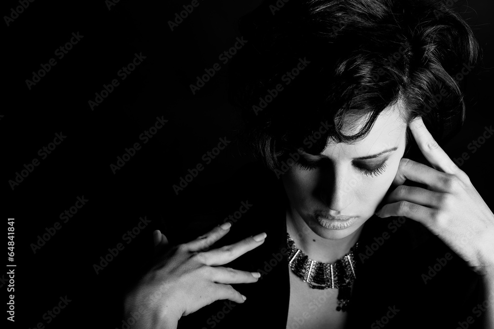 Fototapeta premium Woman with intense look on black background