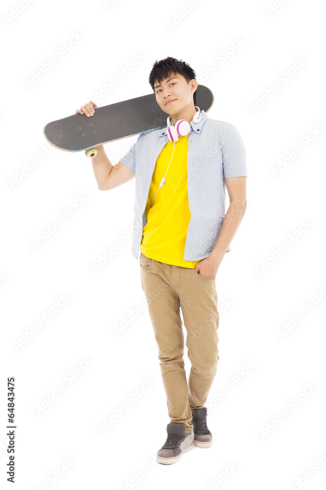 young man standing and holding a skateboard young man standing and holding a skateboard