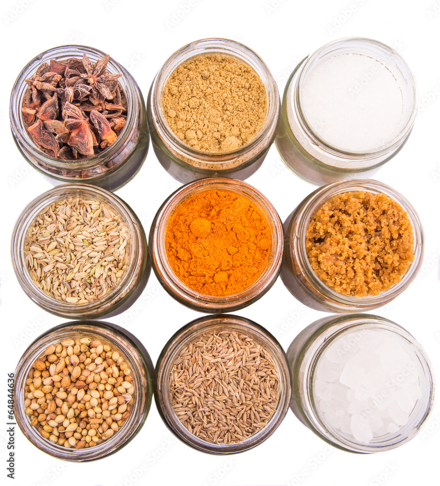 Different variety of sugar and spices over white background Different variety of sugar and spices over white background