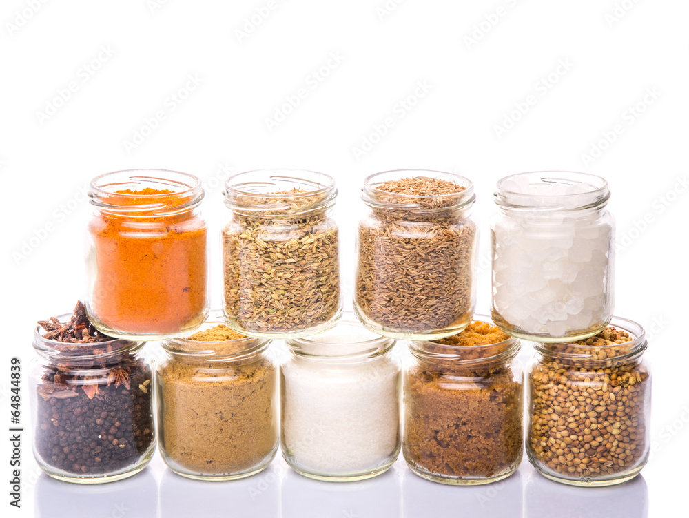 Different variety of sugar and spices over white background Different variety of sugar and spices over white background