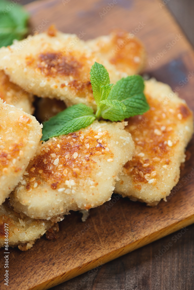 Sesame chicken nuggets with mint leaves, vertical shot Sesame chicken nuggets with mint leaves, vertical shot