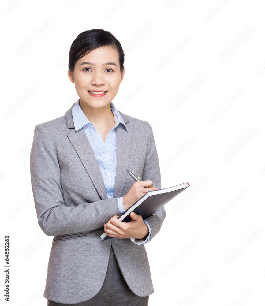 Asian business woman recording on notebook Asian business woman recording on notebook
