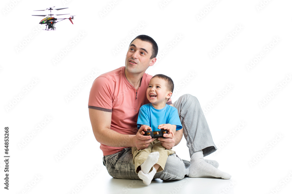 Father and son playing with RC helicopter toy Father and son playing with RC helicopter toy