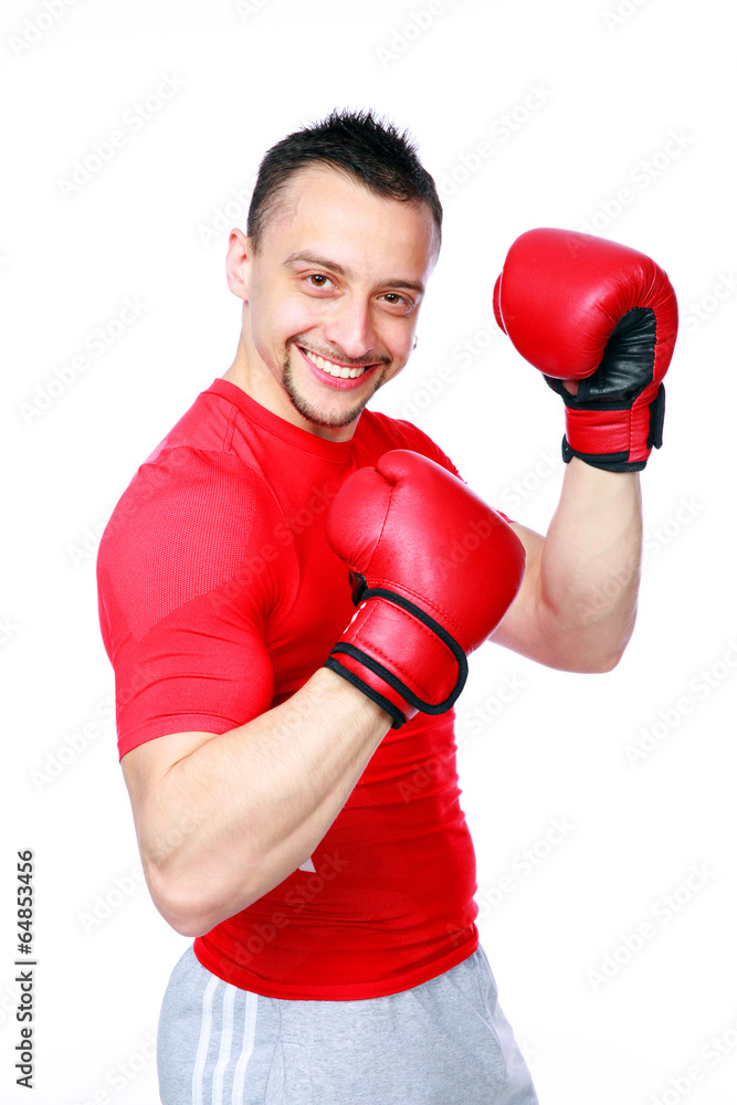Smiling sportsman in boxing gloves standing 