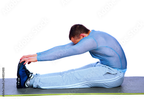 Fitness man sitting and making stretching exercises photo