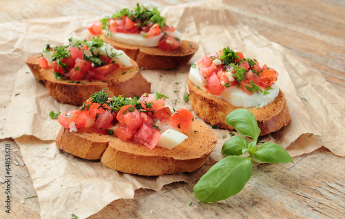 Bruschetta with fresh tomato, cheese and hrebs for breakfast