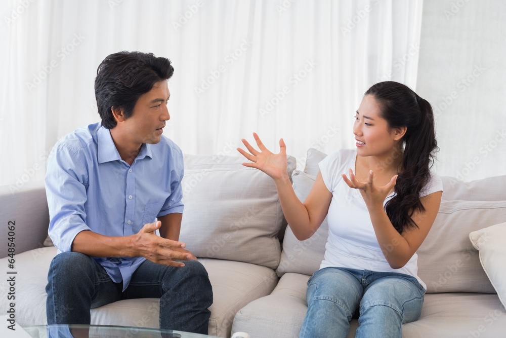 Couple having a dispute on the sofa Couple having a dispute on the sofa