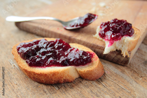 Fresh bread with sweet blackcurrant jam for breakfast