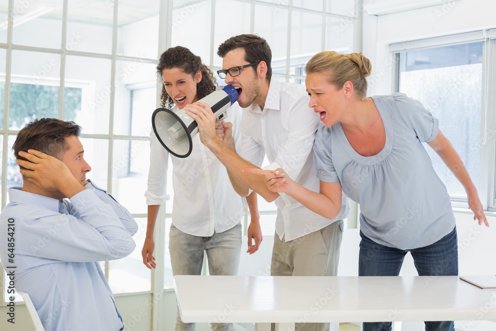 Fototapeta premium Casual business team shouting at a colleague