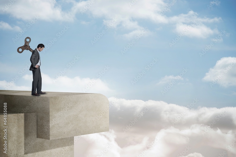 Composite image of wound up businessman with hands on hips Composite image of wound up businessman with hands on hips
