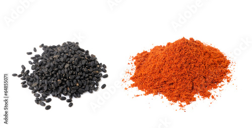 Sesame seeds and paprika powder isolated on white background