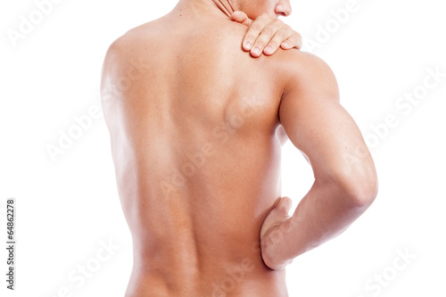 Muscular man holding his back and shoulder in pain, isolated on