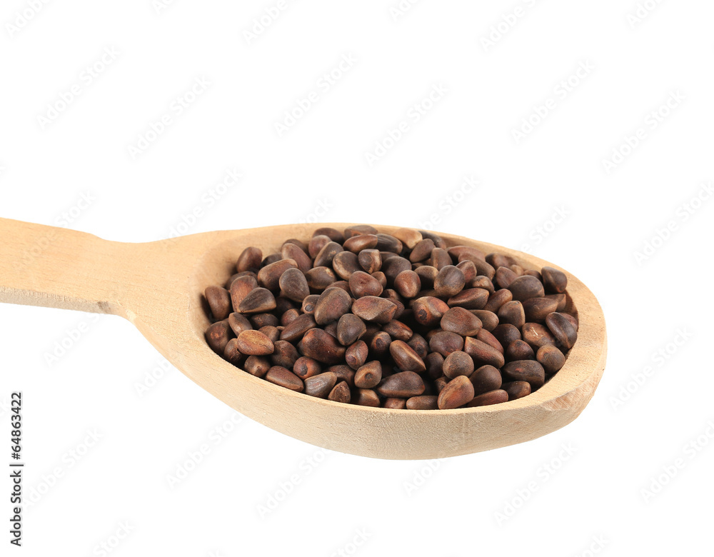 Wooden spoon full with pine nuts. Wooden spoon full with pine nuts.