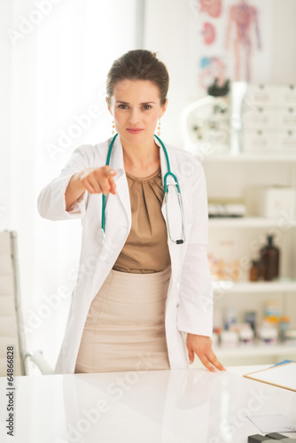 Medical doctor woman pointing in camera