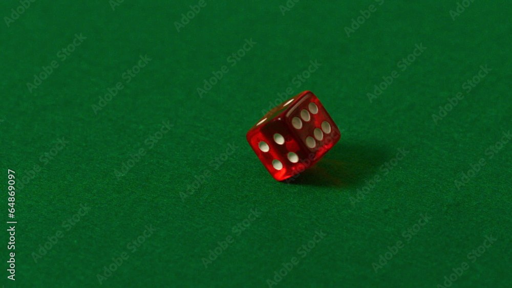 Red dice spinning on casino table Red dice spinning on casino table