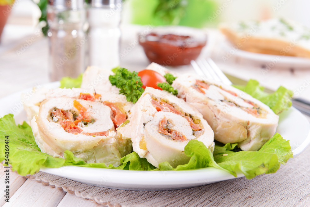 Delicious chicken roll on plate on table close-up Delicious chicken roll on plate on table close-up
