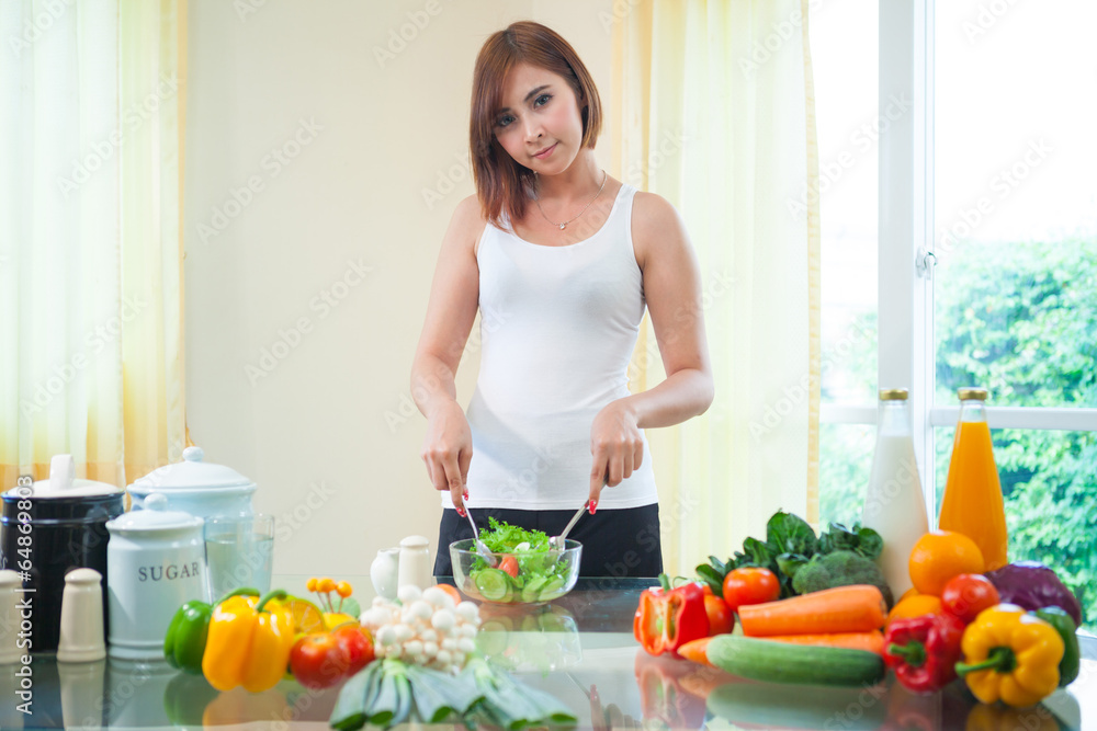Happy woman cooking vegetables green salad Happy woman cooking vegetables green salad