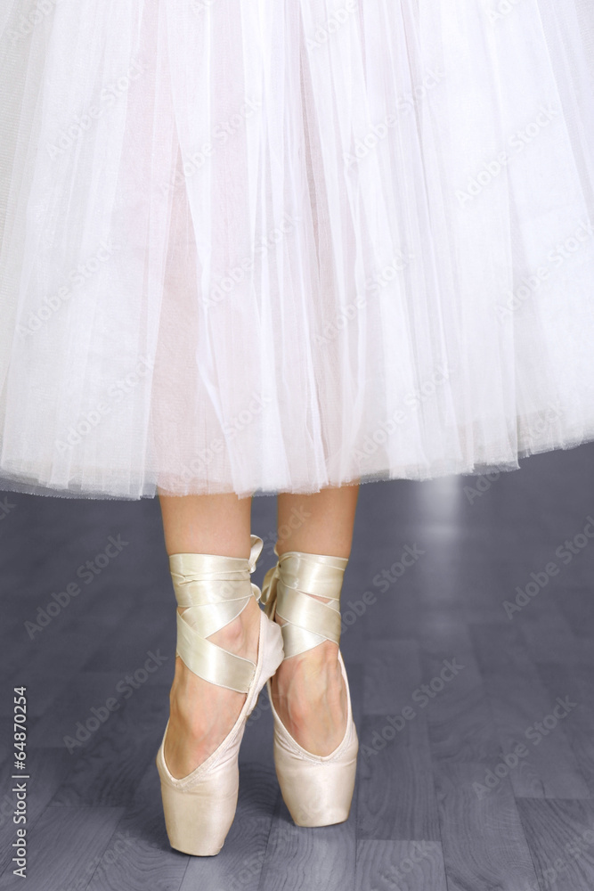Ballerina legs in pointes in dancing hall Ballerina legs in pointes in dancing hall