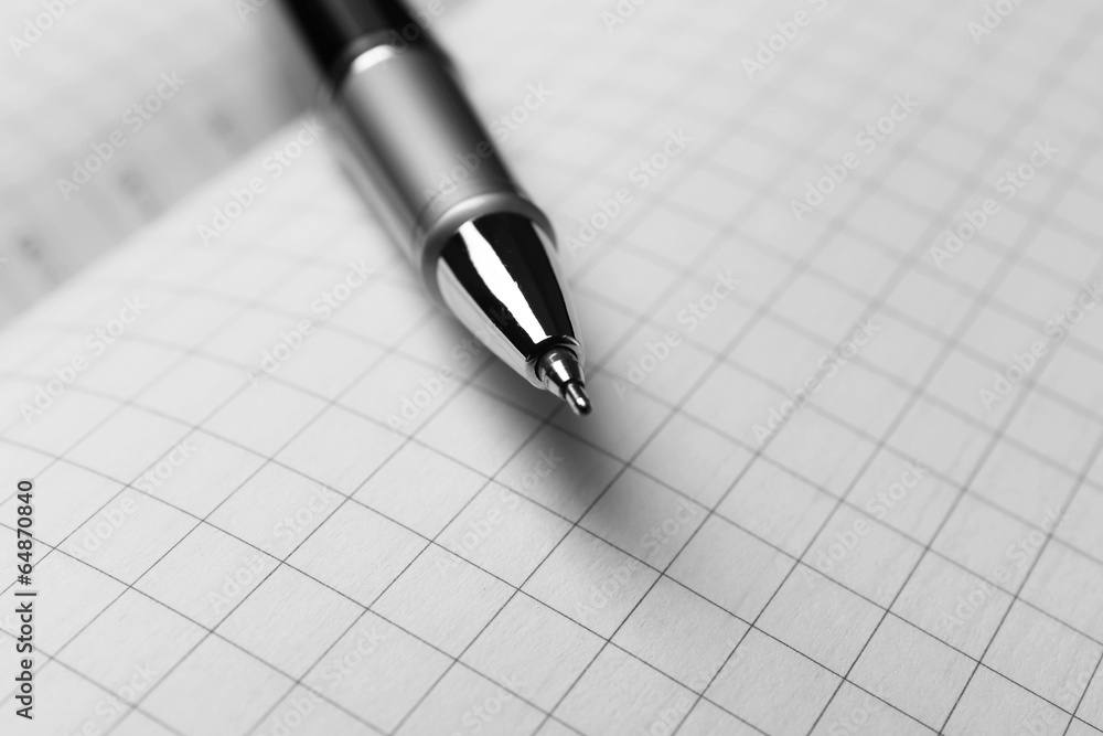 Pen on opened book, close up Pen on opened book, close up