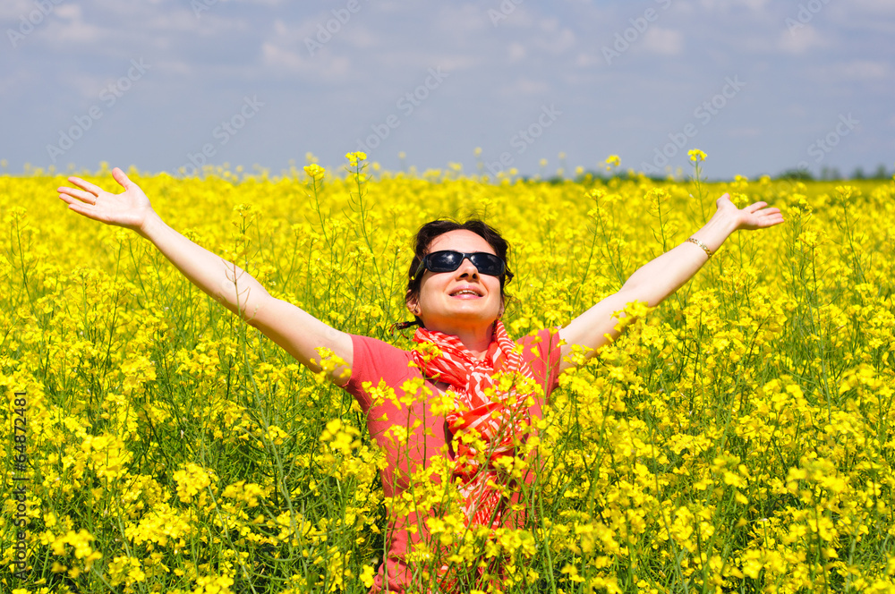 Naklejka premium Young woman in a rape field