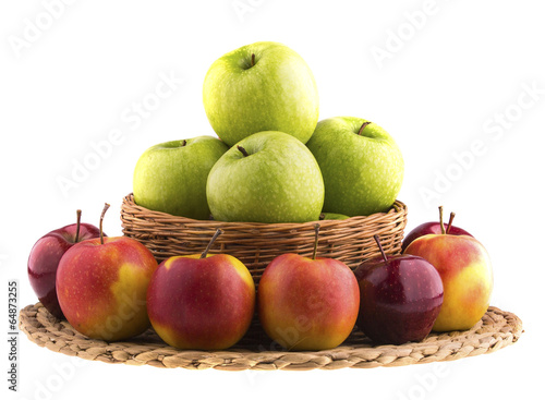 Green and red apples in a wicker baskets.