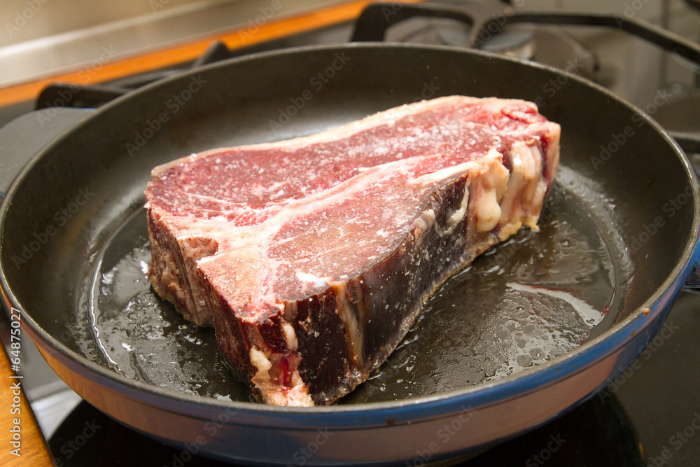 t-bone steak in a pan t-bone steak in a pan