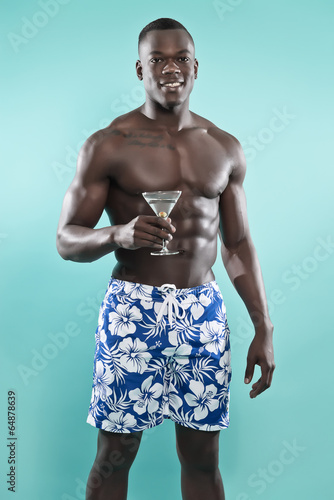 Summer black african american muscled fitness man holding cockta photo