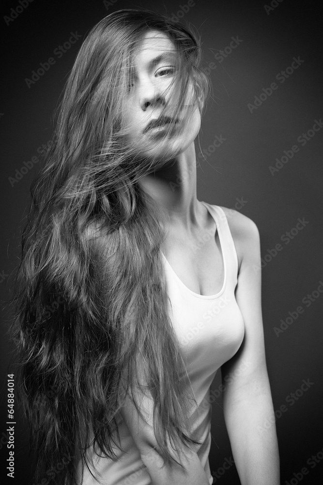 Beautiful young model posing on dark background.