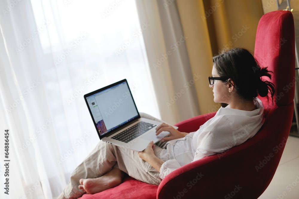 woman using a laptop computer at home woman using a laptop computer at home