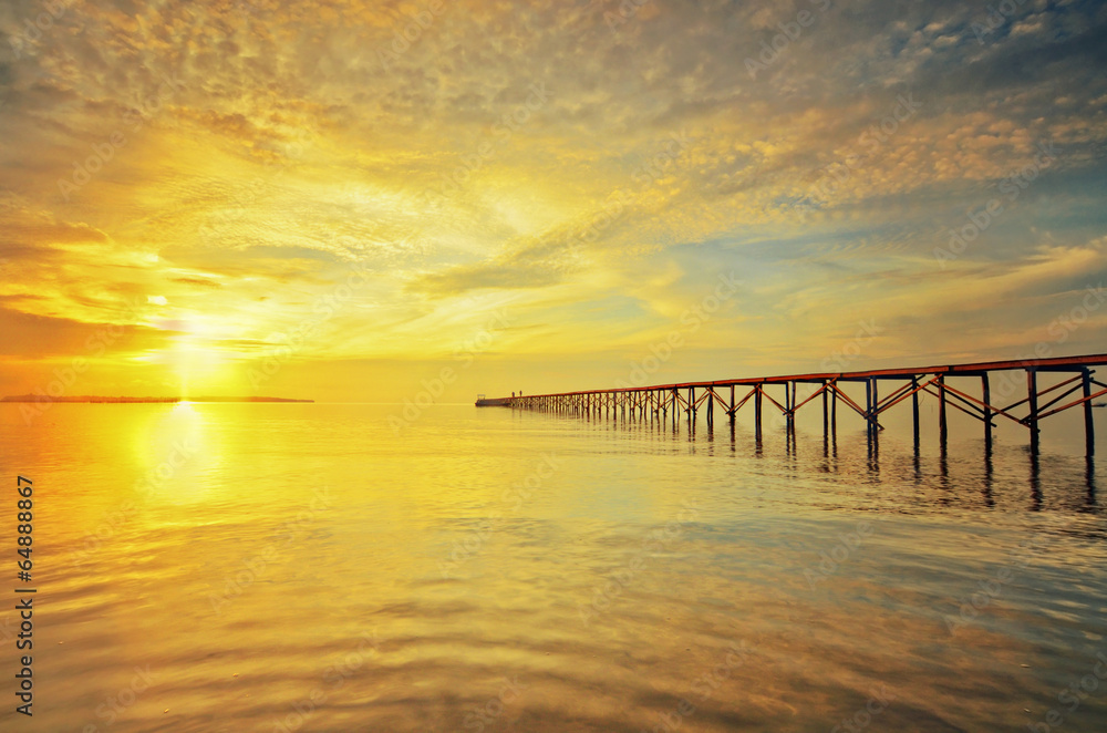 Jetty silhouette at sunset on Jeram Beach, Malaysia