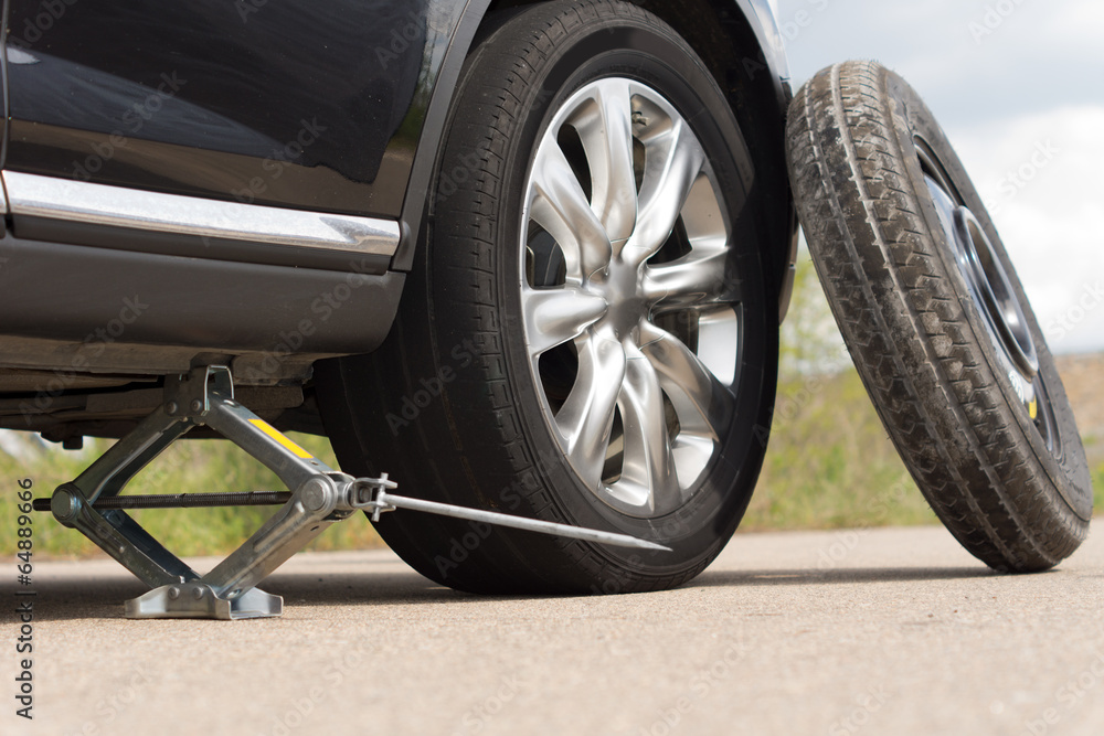 Jacking up a car to change a tyre