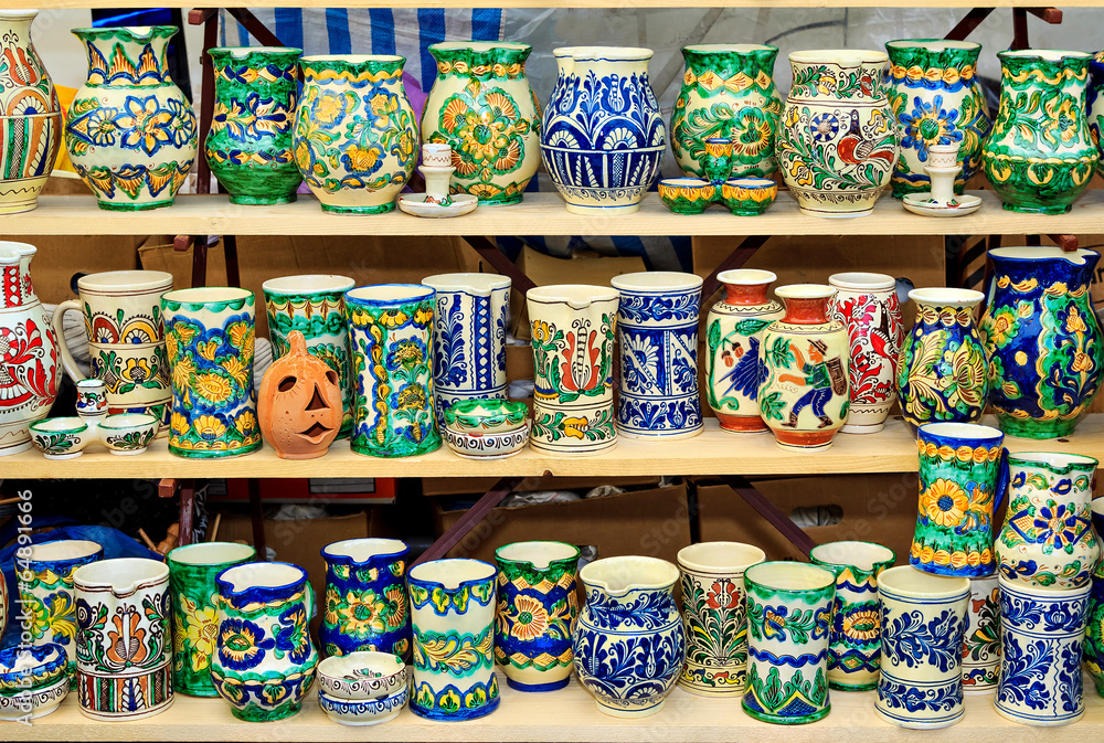 Colorful ceramic jugs on the shelf Colorful ceramic jugs on the shelf