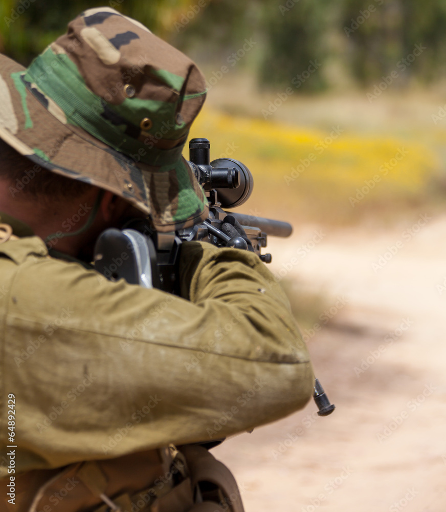 Fototapeta premium soldier aiming with a sniper rifle