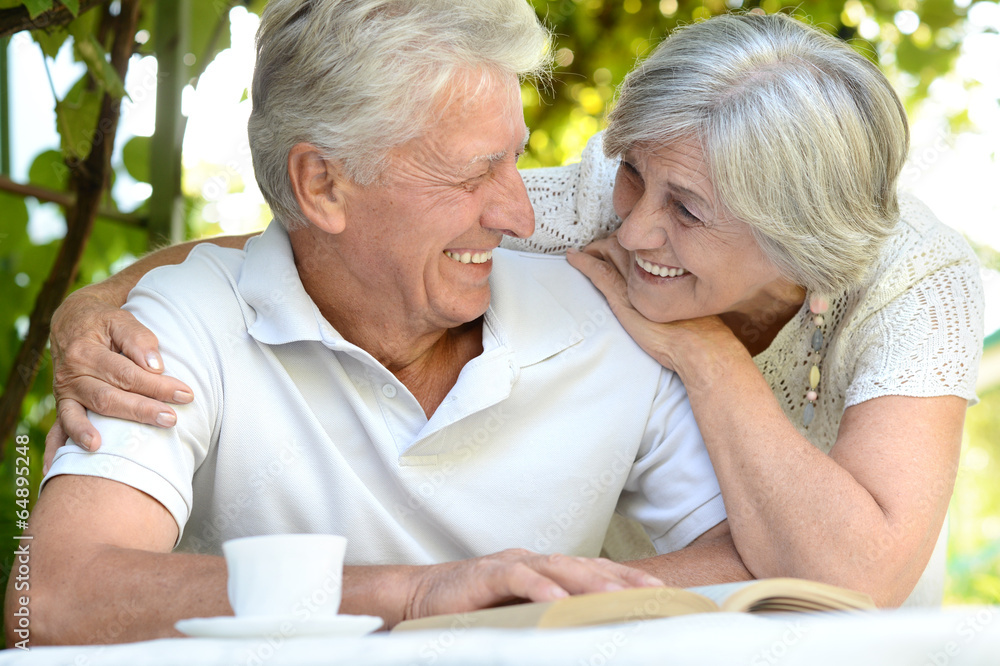 Beautiful older couple resting in the garden Beautiful older couple resting in the garden