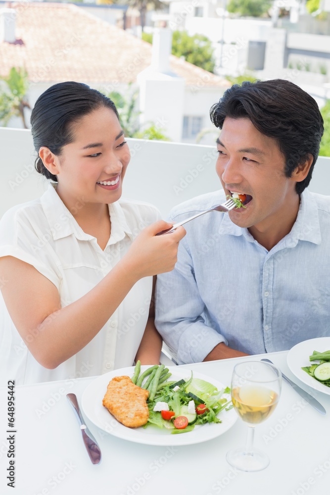 Happy couple having a meal together with white wine Happy couple having a meal together with white wine