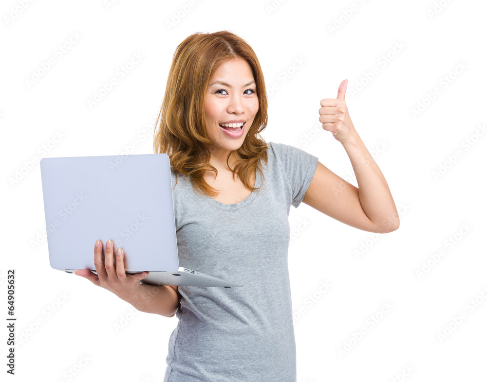 Young woman holding laptop making thumb up Young woman holding laptop making thumb up