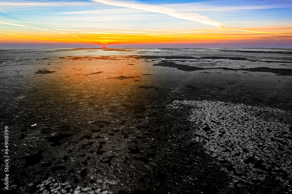 Landscape with frozen sea at beautiful winter sunrise.