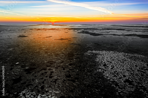 Landscape with frozen sea at beautiful winter sunrise.