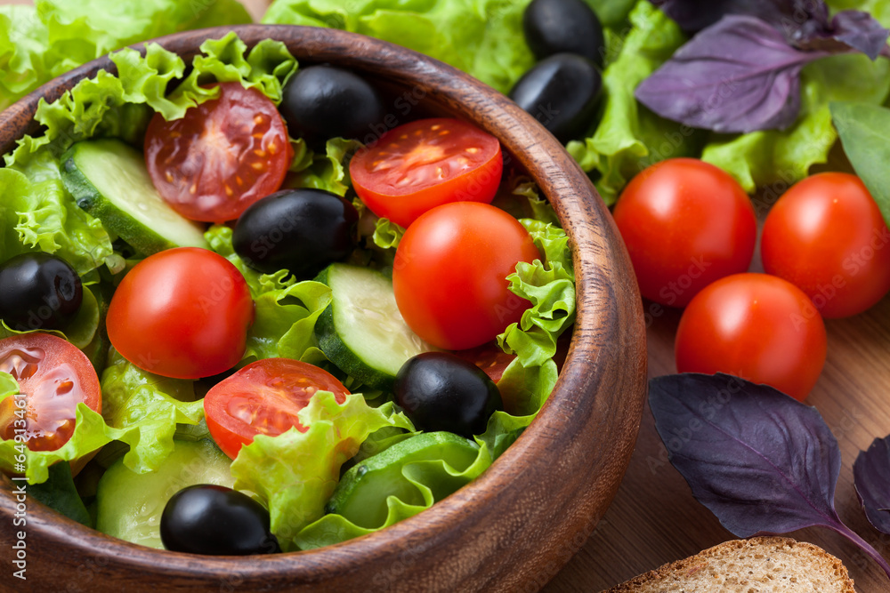 Salad on wooden plate. Salad on wooden plate.
